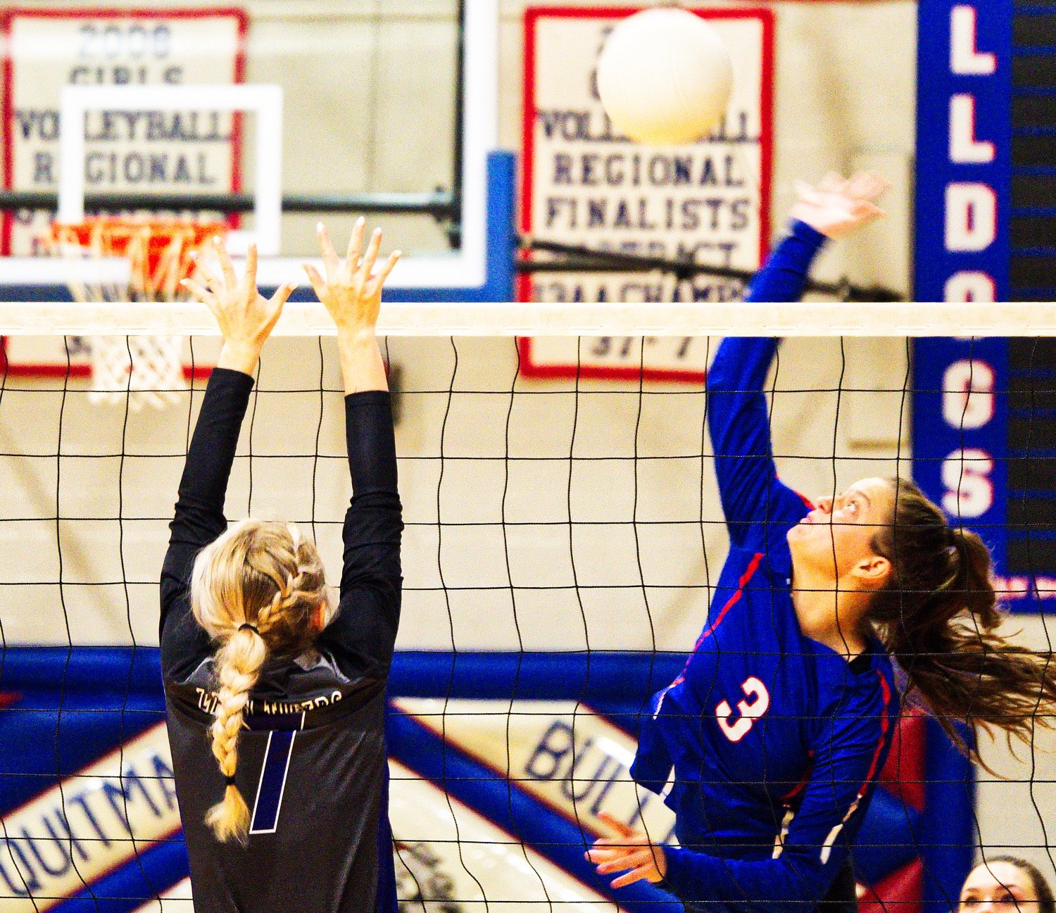 Maddy Pence swats a kill over the net and defense. [Dig this? Get a print.]